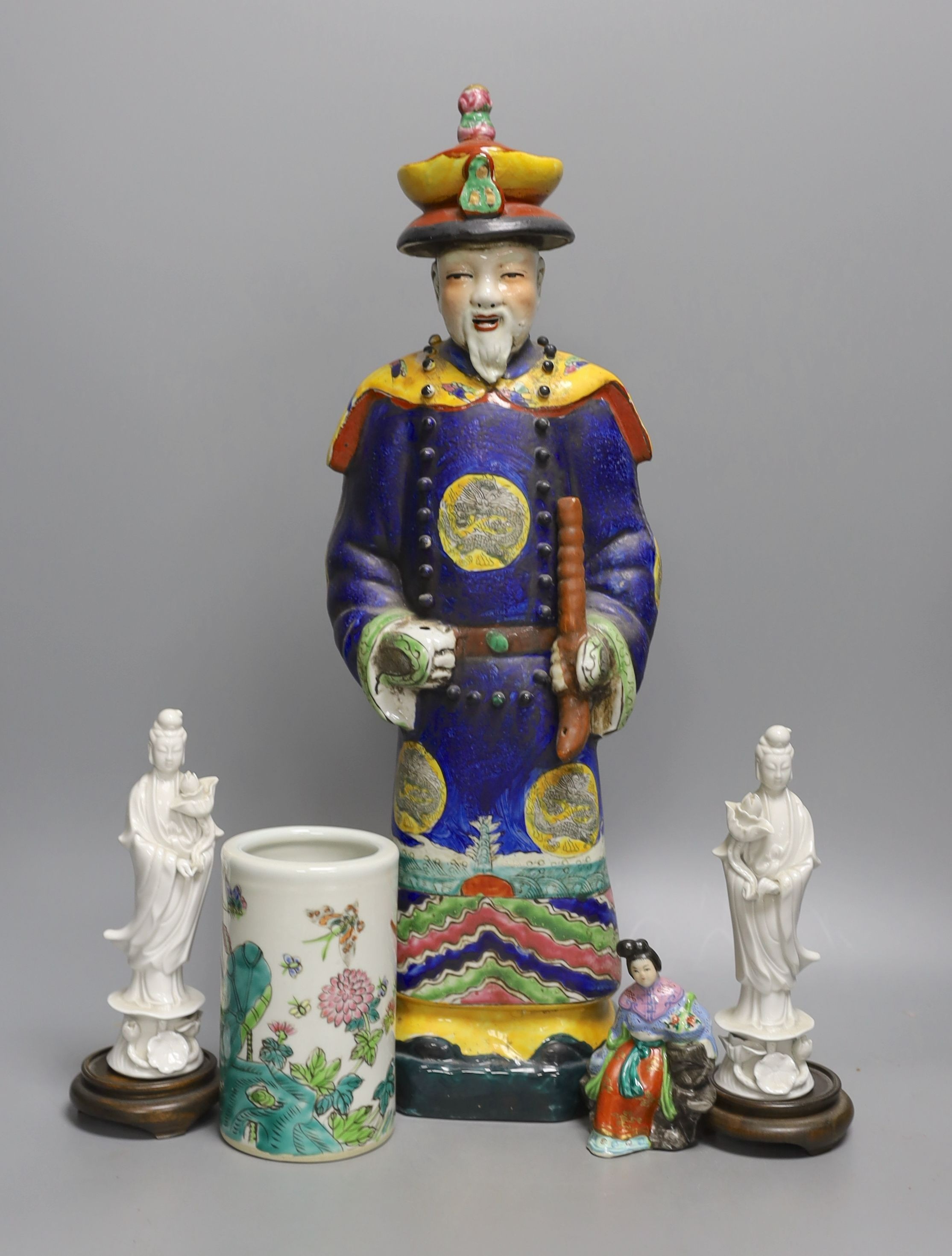 A Chinese brush pot, a pair of blanc de chine deities, a famille rose early 20th century figure, and a Kangxi emperor brush holder (5) - 45cm tall